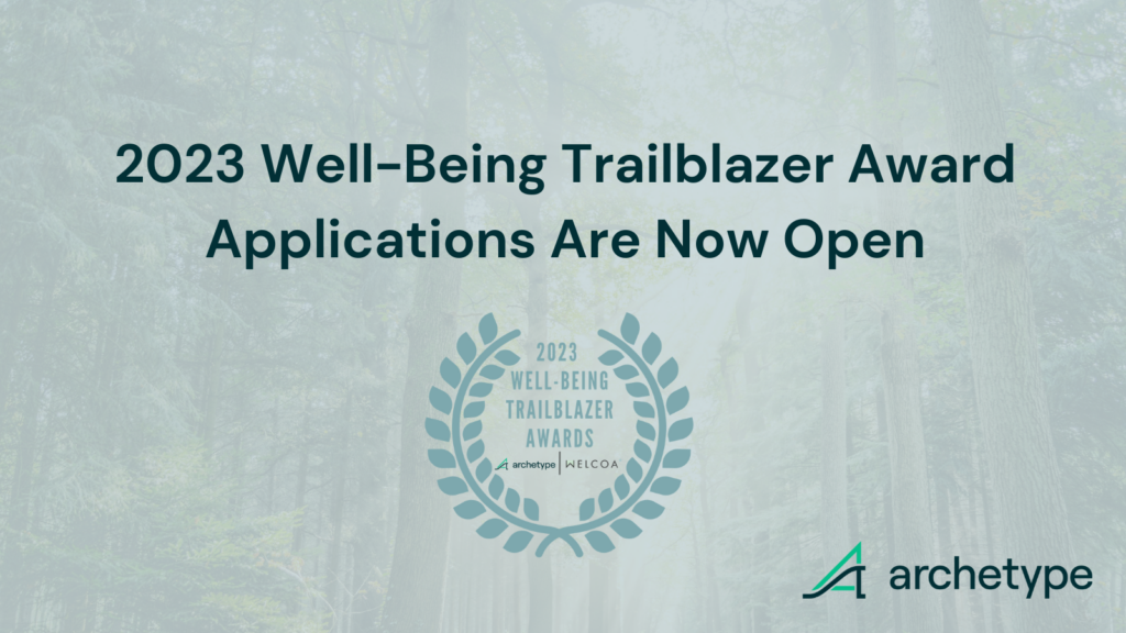 image of well-Being Trailblazer award logo with text "2023 Well-Being Trailblazer Award Applications Are Now Open." Background image of picture is of a forest with a light green opaque overlay.